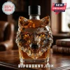 Crystal decanter shaped like a geometric wolf head containing amber liquor on a wooden desk!