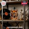 Crystal liquor bottle shaped like a wolf head with amber liquid on a rustic metal shelf with vinyl records!