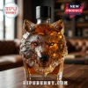 Crystal whiskey decanter shaped like a geometric wolf head containing amber liquid on a wooden table!