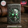 Heavy metal zippo lighter, gray skull design with bright green glowing eyes and cracks, text 