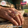 Gold Oklahoma Sooners 2026 NCAA baseball championship ring with red stones and diamonds on a man's finger.!
