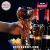Clear glass beer mug shaped like a world cup trophy held in a hand with two Budweiser bottles in the blurred background.!