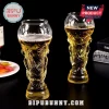 Two clear glass beer mugs shaped like the FIFA World Cup trophy filled with golden lager against a black background.!