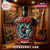 AC/DC 50th anniversary black whiskey bottle featuring Angus Young, lightning bolts, and gold flame detailing.!