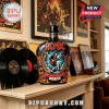 AC/DC 50th anniversary black glass liquor bottle with Angus Young graphic, flame details, and 1973-2026 text on a mantel.!