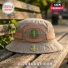 Tan cotton bucket hat with Alpha Kappa Alpha embroidery, 1908 text, and a metal sorority pin on a wooden park bench.!