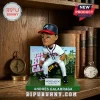 Andrés Galarraga Braves bobblehead figurine on a green base with a Big Cat backdrop in front of a wooden bookshelf.!