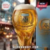 Argentina AFA 133rd anniversary beer glass shaped like a World Cup trophy filled with golden beer against blurred bokeh.!