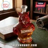 Faceted red glass Arkansas Razorbacks whiskey decanter with a diamond-shaped stopper on a leather-topped library desk.!