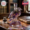 Purple and gold crystal raven decanter on a wooden desk with etched text Purple Rising Est. 1996 Baltimore Ravens.!