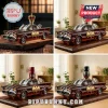 Amber glass Batmobile car decanter with 60th Anniversary 1966-2026 emblem on a dark wooden display base.!