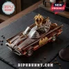 Amber glass Batmobile whiskey decanter with gold crown stopper, Bat logo, and 60th Anniversary plaque on black slate board.!