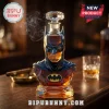 Batman glass whiskey decanter bust with a diamond-cut stopper, amber liquid, and a black and yellow bat logo emblem.!