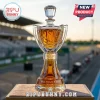 Crystal trophy shaped whiskey decanter filled with amber liquid, labeled Bill France Cup Whisky on a racing track background.!