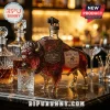 Buffalo-shaped glass decanter with a metal harness and buffalo stopper on a marble countertop with crystal barware.!