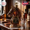 Amber glass horse head whiskey decanter with gold-tone metal stopper and Blanton's label on a wooden bar counter.!