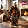 Amber glass horse head whiskey bottle with gold bridle topper on a wood table in front of a stone fireplace.!