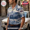 Man wearing a blue and white patterned button-down shirt featuring BMW car illustrations, logos, and Bavarian landscapes.!