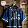 Navy blue Red Sox baseball jersey with a Scotland flag patch and diamond pattern, hanging on a wooden hanger.!