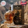 Buffalo Trace bison-shaped glass bourbon bottle next to Yellowstone King box on a rocky ledge with waterfall background.!