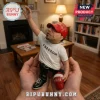 Resin figurine wearing a red Make America Great Again cap and white Freedom t-shirt held in hands with a fireplace background.!