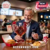 Man holding a red glass rooster-shaped whiskey decanter labeled Chick-fil-A 80th Anniversary in a restaurant setting.!