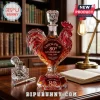 Rooster-shaped crystal whiskey decanter with Chick-fil-A 80th anniversary text on a wooden library desk.!