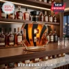 Cincinnati Bengals logo shaped glass whiskey decanter with black stripes and a dark hexagonal stopper on a wooden bar shelf.!
