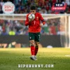 Cristiano Ronaldo wearing a red and green Portugal soccer jersey kissing a soccer ball on a stadium pitch.!
