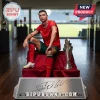 Cristiano Ronaldo in a red Portugal national soccer kit sitting next to a trophy on a platform with a metal nameplate.!
