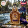 Crown Royal Northern King whiskey bottle with a glass moose-shaped topper, gold cap, and purple velvet pouch on mossy log.!