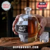 Daft Punk helmet shaped glass decanter with chrome and gold finishes containing amber whiskey on a wooden surface.!