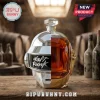 Daft Punk helmet-shaped glass decanter filled with amber whiskey, set on a wooden table in a rustic cellar background.!