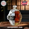 Daft Punk helmet shaped glass decanter with chrome finish, half-filled with amber liquid on a rustic wooden table.!