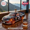 Black Dale Earnhardt No. 3 Monte Carlo car-shaped glass whiskey decanter with orange tinted wheels on a wooden deck.!