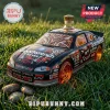 Monte Carlo NASCAR stock car shaped glass liquor bottle with Goodwrench graphics sitting on green grass outdoors.!