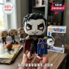 Danhausen vinyl figure in Knicks jersey with face paint and cape held in hand against blurred room background.!