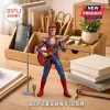 David Bowie Ziggy Stardust action figure holding a red electric guitar with a silver microphone stand on a wooden desk.!