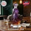 Cthulhu-shaped purple crystal whiskey decanter with gold armor accents on a wooden table with a glass and cigar.!