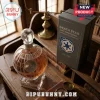 Glass Death Star whiskey decanter on a wooden desk next to a grey commemorative box labeled Death Star 50th Anniversary.!