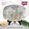Disney 100 Years Winnie the Pooh oval ceramic decorative plate featuring watercolor illustrations on a black stand.!