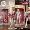 Dolly Parton Rhinestone Cowgirl action figure with blonde hair, white suit, and pink acoustic guitar in box packaging.!
