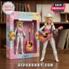 Dolly Parton collectible action figure wearing a white fringed cowboy outfit, holding a pink acoustic guitar with box.!