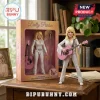 Dolly Parton action figure in a white rhinestone jumpsuit with a pink acoustic guitar and matching display box packaging.!