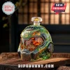 Doom 33rd anniversary green faceted glass helmet decanter with metallic accents on a wooden table.!