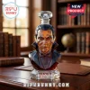 Facetted glass Dracula bust decanter with 95th Anniversary engraving on a wooden desk against a library background.!