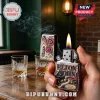 Elton John themed Zippo lighter with piano and sunglasses artwork held by a hand next to two whiskey glasses.!