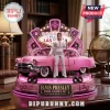 Elvis Presley collectible figure standing next to a pink Cadillac, set on a lighted base with Las Vegas sign background.!