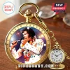 Gold pocket watch featuring an Elvis Presley portrait, star engravings, and a quartz clock face on a wooden surface.!