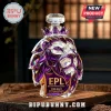 Crystal English Premier League lion head decanter with purple facets and 35th anniversary text on wooden table.!